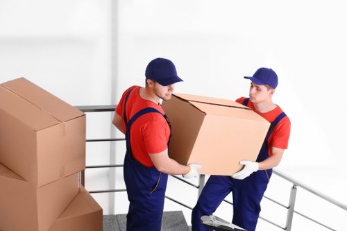 Professional movers handling office equipment during relocation